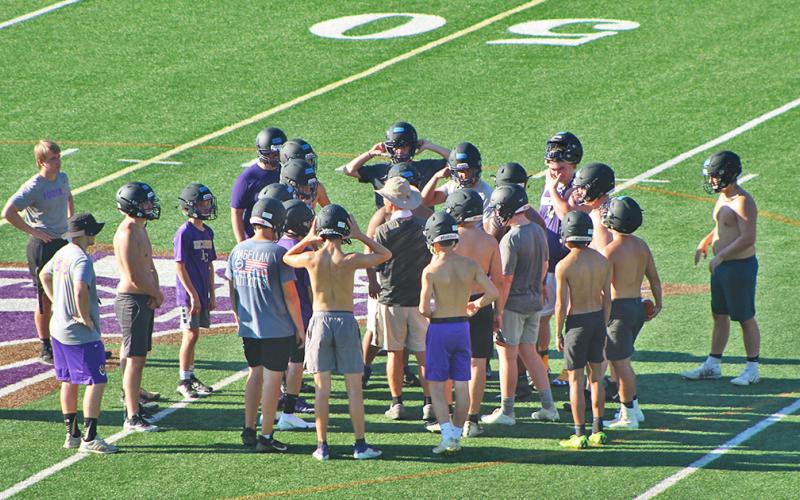 LCHS head football coach Caleb Sorrells huddles up with his players during the first day of mandatory practice on Monday.
