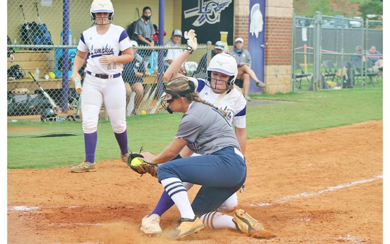 Lady Indians right fielder Haley Voyles slides in safely at home after a wild pitch by White County’s pitcher. Voyles had a solid performance against the Lady Warriors in the Lumpkin win.