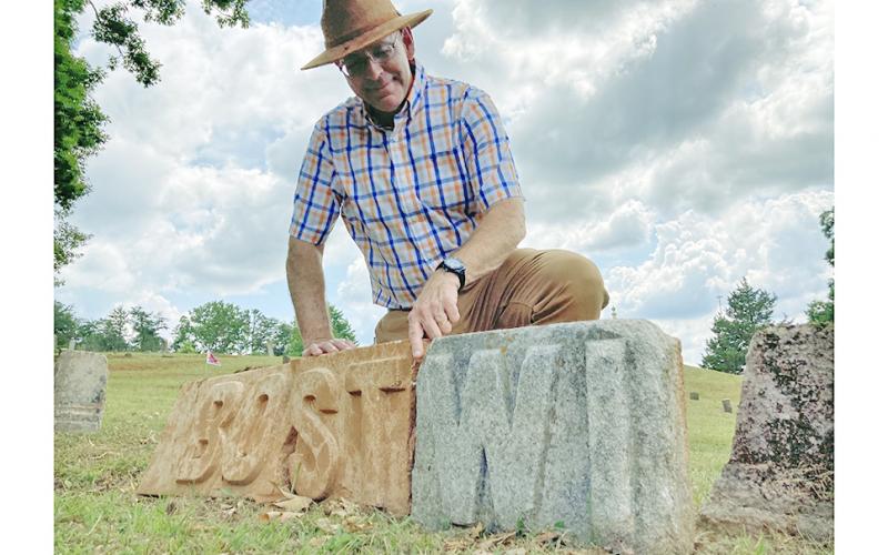 Local historian Chris Worick examines some mysterious stone letters found recently in Dahlonega’s Mount Hope Cemetery.