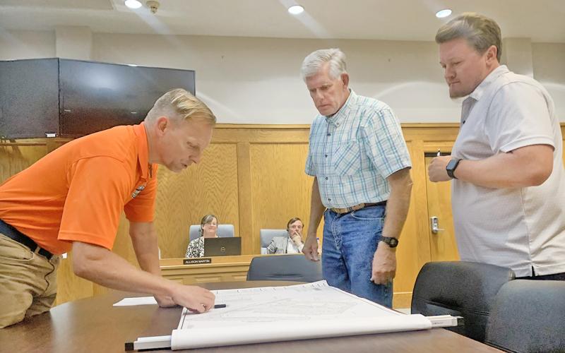 City Engineer Mark Buchanan, left, describes the layout for the upcoming Whataburger franchise property as council members Ross Shirley, middle, and Ryan Reagin look on.