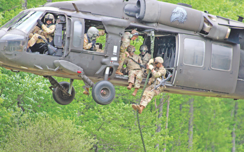 A fire team of Rangers from the U.S. Army’s 5th Ranger Training Battalion demonstrate a “fast rope” insertion from a UH-60 Black Hawk helicopter at Camp Frank D. Merrill on Saturday.