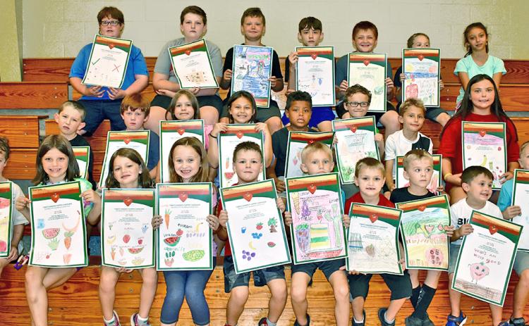 Park & Rec’s Day Camp participants took part in a poster contest for Community Helping Place Free Medical and Dental Clinics annual Tomato Sandwich Supper. Winners (first, second and third place) will be revealed Thursday, July 18, at Dahlonega Baptist Church during the event. Pictured are (first row, from left) Jacob Giles, Charlotte Gass, Madeline Gass, Jersey Ward, Colby Henderson, Micah Ellis, Christian Cotour, Landen Popham, Harlen Wager and Joey Moses; (second row, from left) Ethan Starley, Talon Ston