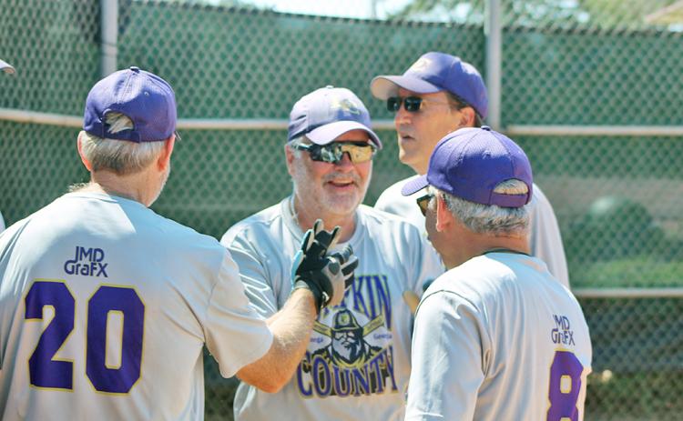Lumpkin County Miners player/coach John “Da Boss” Daley gets a healthy dose of high-fives after belting a three-run, inside-the-park home run versus the Dahlonega Gold during a Clayton League doubleheader last week.