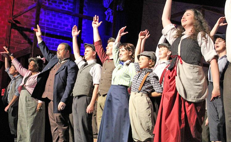 The cast of Newsies at The Holly takes a bow following its final rehearsal on Thursday, July 25. The show is filled with high energy dances and songs and keeps the audience engaged throughout, often taking the action off the stage and into the crowd. The musical is scheduled to run the next two weekends (August 2-4 and 9-11).