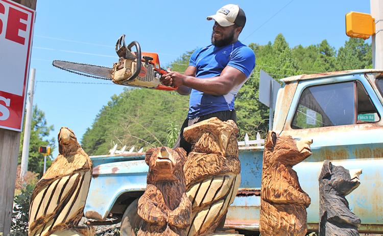 Devonte Young has spent years honing his craft as a chainsaw artist while working under the tutelage of renowned carver Michael Von Schroth. You can usually find Young and his carvings on the corner of Long Branch Road and Highway 52.