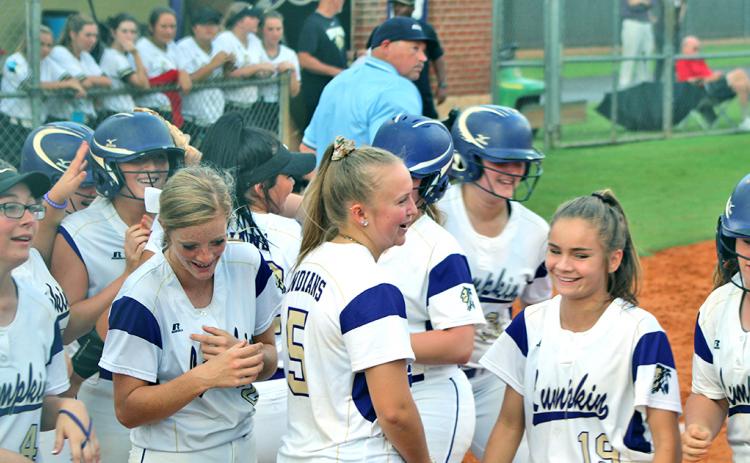 Evee Dornhecker is mobbed by her teammates after belting a game-tying solo shot to left field during the Lady Indians' game versus East Hall.