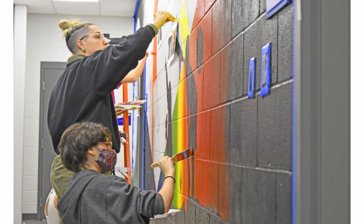 UNG students Cagney Collins and Boston Sundstrom paint the hallway of the new observatory. The observatory is open to the public every clear Friday and Saturday night.