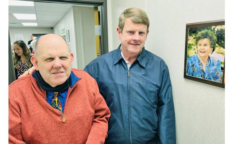 David (left) and Eddie Green stand beside a plaque honoring their late mother, Anne, for whom the new clinic is named. She was one of the free clinic’s most ardent supporters from the beginning, whose idea of holding a tomato sandwich supper became its signature fundraiser each year.