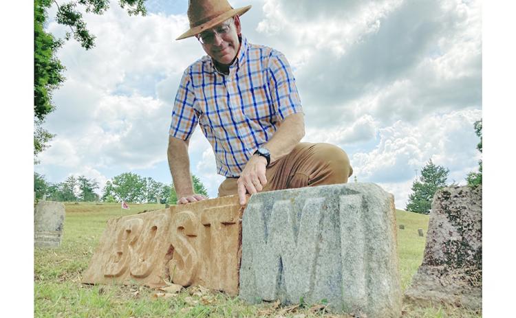 Local historian Chris Worick examines some mysterious stone letters found recently in Dahlonega’s Mount Hope Cemetery.