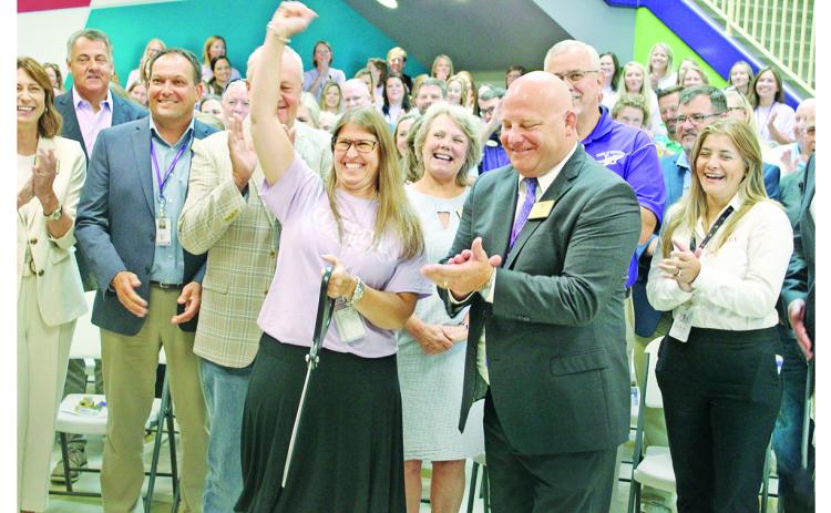 Cottrell Elementary Principal Stacie Gerrells celebrates next to Superintendent Rob Brown and other officials after cutting the ceremonial red ribbon to mark the grand opening of the new school.