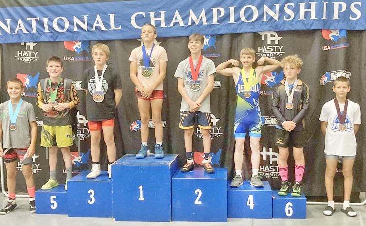Lumpkin’s Liam Nielsen stands on the 4th place podium at the Kids Nationals competition.