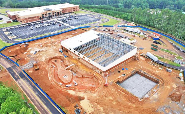 A drone photograph by Carroll Daniel Construction on August 11 shows an aerial view of the progress at the Pinetree Recreation Center site. Cottrell Elementary School is visible in the background.