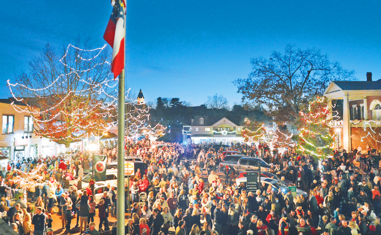 Thousands of visitors and locals filled the downtown area for the lighting of the square on Friday.  Local musicians Radford Windham and Chuck Bell filled the night air with holiday music before and after.  On hand to perform the ceremonial lighting of the square were UNG President Michael Shannon, Dahlonega Mayor JoAnne Taylor and Lumpkin County Chairman Chris Dockery. (Photo by John Bynum)
