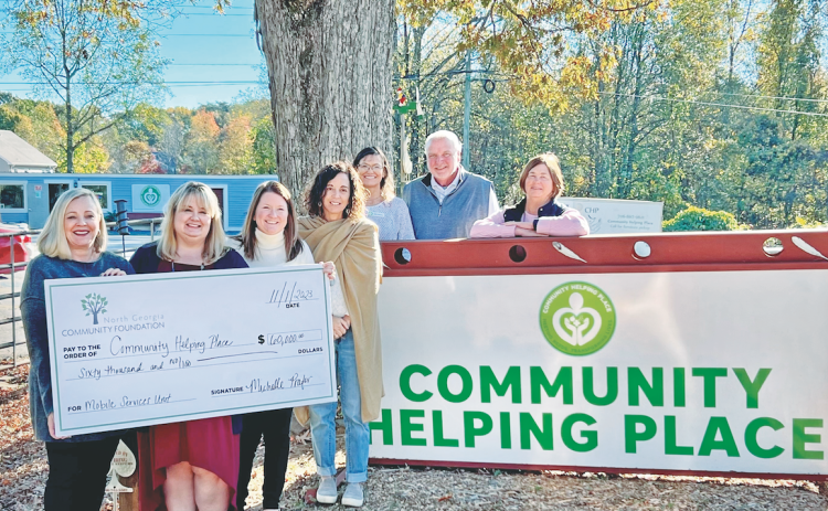 North Georgia Community Foundation President Michelle Prater (pictured, from left) presents a grant check in the amount of $60,000 to Community Helping Place to establish a new Mobile Service Unit. Also pictured are CHP Executive Director Melissa Line, Abigail Carter, Paula Payne, Debi Holloway, CHP Board Chair Brian Hinkel and Barbara Williams.