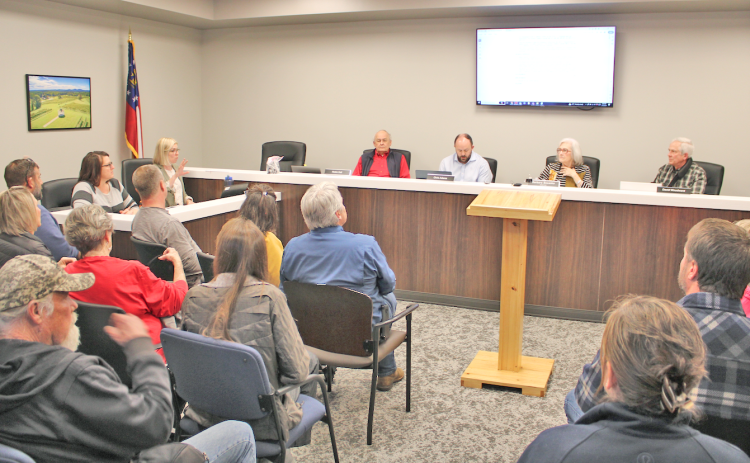 A capacity crowd gathered inside and outside the planning commission meeting room Monday night to make their voices heard on a proposed mixed use development for Dawsonville Highway and Pink Williams Road.