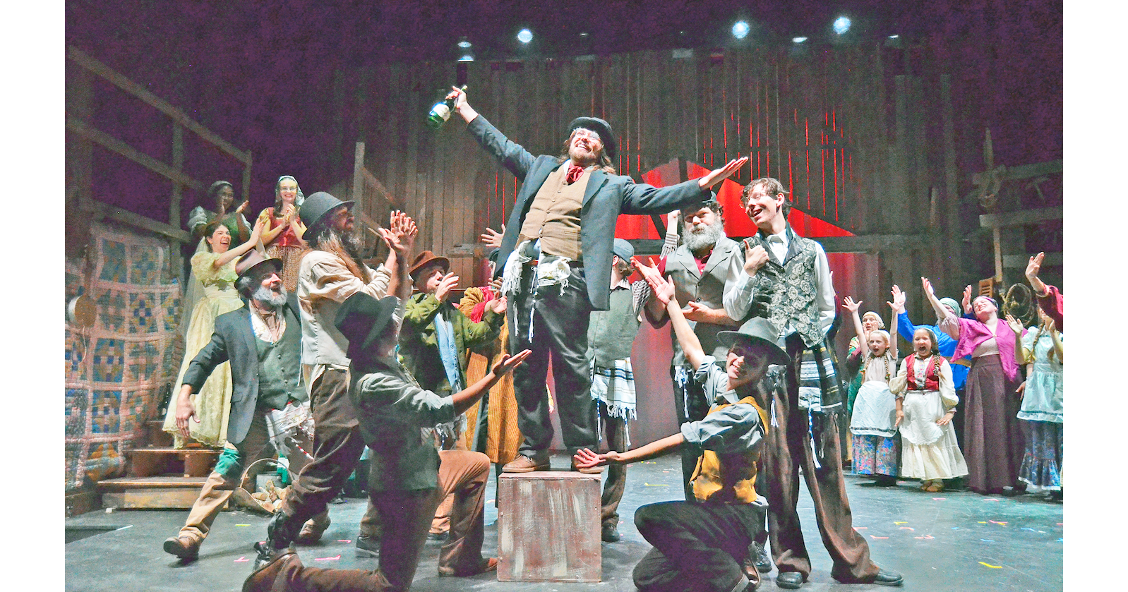 The sizable singing, dancing, music-making cast of Fiddler on the Roof will fill the stage at The Holly Theater over the next two weekends. (Photo by Sean Newman)