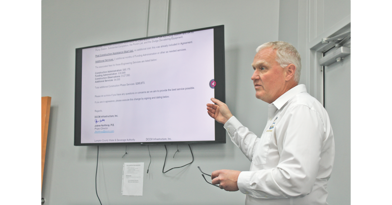 Water and Sewage Authority Executive Director Sean Phipps gestures toward a letter from DCCM requesting a six month extension and $265,673 in additional construction phase services to complete the Cane Creek Wastewater Treatment Plant.