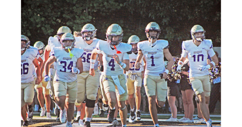 Starting quarterback Kolson Howell leads the Indians onto the field during their Spring Game at East Hall.
