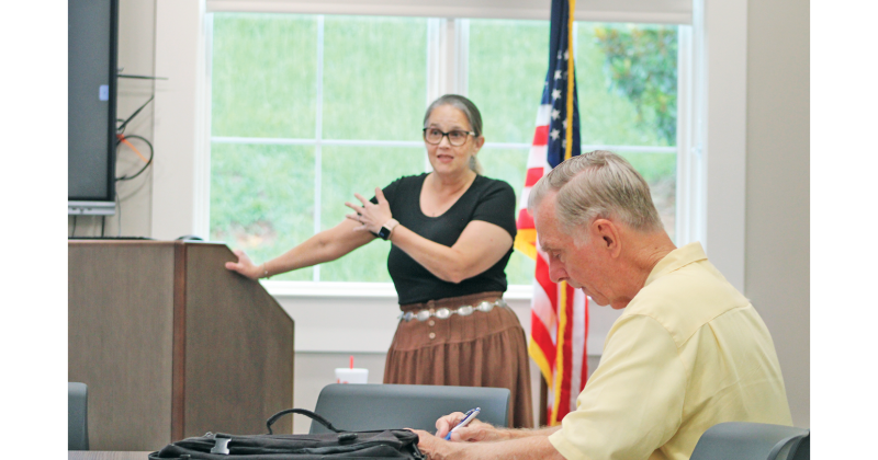 A local resident takes notes as Anita Anderson Spangler with Citizens for a Free Lumpkin speaks during a recent Homestead Property Tax Relief Seminar held in the library’s meeting room.