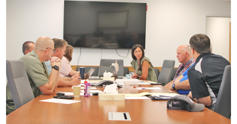 Lumpkin County Finance Directory Abby Branan (center) speaks to the Board of Commissioners during an August 7 special called meeting. Ultimately, the Board settled on a scaled-back 2027 budget of $34,674,700 with a full rollback of the local millage rate used to calculate real estate property taxes.