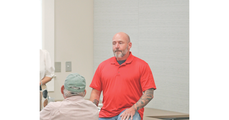 Officer Matthew Cook speaks about his use of the Flock system as an employee of the Gainesville Police Department during a townhall-style meeting hosted by Citizens for a Free Lumpkin.