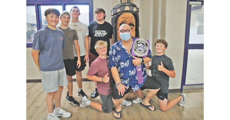 Josh Passmore gathers for a photo with some of his former athletes.