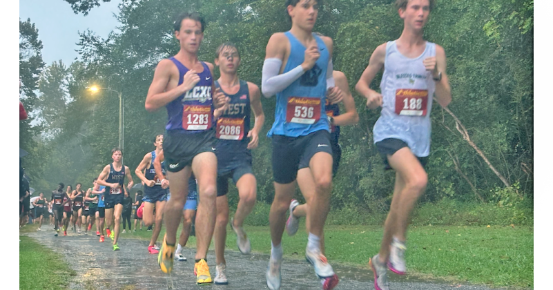 Lumpkin County’s Witt Windham (left) keeps pace with the leaders before sprinting away for the win.
