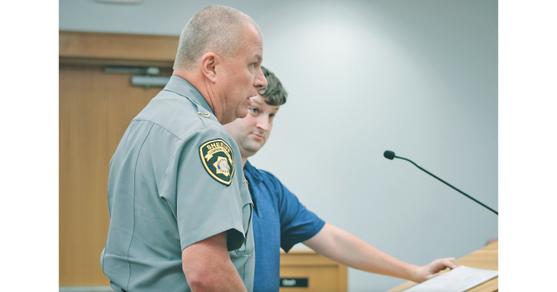 Lumpkin County Sheriff Stacy Jarrard reveals new efforts to regulate the Flock License Plate Reader system during a recent Board of Commissioners meeting, as surveillance opponent Robbie Ward looks on.