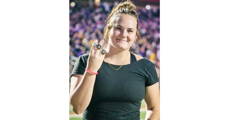 Lumpkin wrestler and State Champion Faith Jones shows off her State rings. 