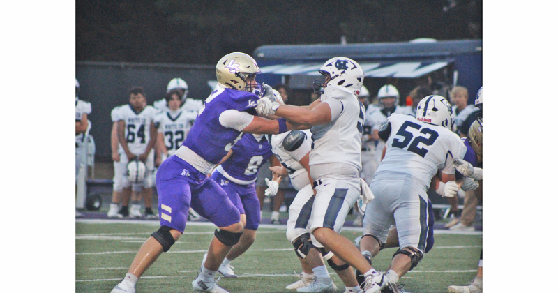 Senior Caleb Soles locks up with a White County lineman during last week’s game.