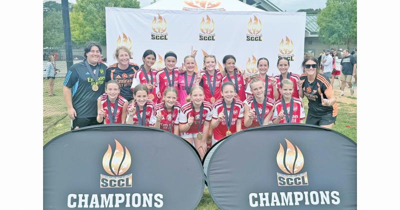 UFA Mountains U13G Academy celebrates their championship win.