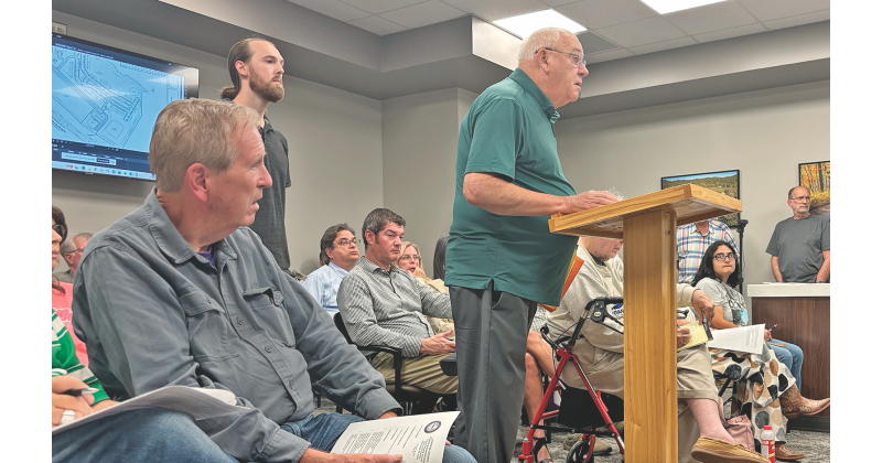 Project engineer Dave English addresses the Lumpkin County Planning Commission in a packed meeting room last Monday.  A development deemed Legends at Chestatee would bring a 272-unit apartment complex and more to the end of Highway 400, if approved as is.