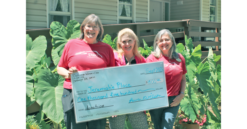 Dahlonega Woman’s Club President Laura Wilson (left) and Co-President Ali Murphy (right) present a check for $1,500 to Jeremiah’s Place Executive Director Della Lago. “Our number one goal is to raise money to support Lumpkin County residents,” Murphy said.