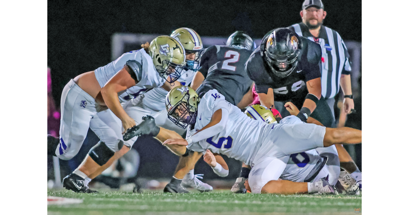 Gannon Melanson and the Lumpkin defense battle to make a stop.