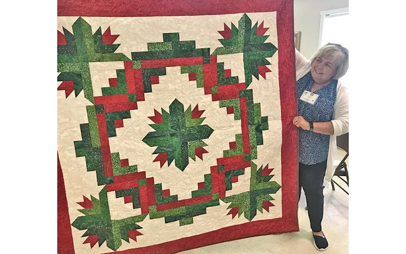 Lynda Duke stands beside the Christmas quilt that will be raffled off Friday, July 26 at The Common Thread. The raffle is part of the shop’s Christmas in July Quilt Show, free and open to the public. Raffle tickets are $5 and proceeds go to support the Dahlonega Valor Quilters, who provide quilts to Lumpkin County’s veterans as a thank you for their service.