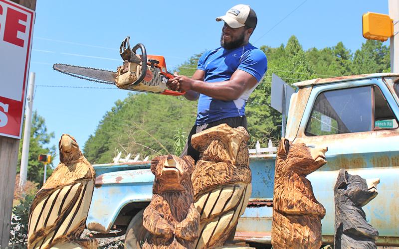 Devonte Young has spent years honing his craft as a chainsaw artist while working under the tutelage of renowned carver Michael Von Schroth. You can usually find Young and his carvings on the corner of Long Branch Road and Highway 52.