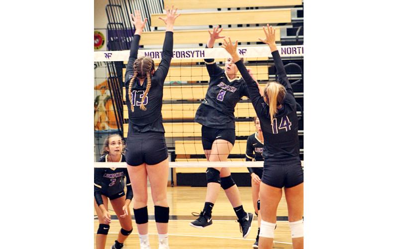 Mackenzie Caldwell delivers a powerful spike for a Lumpkin point during the team’s season opening match against North Forsyth.