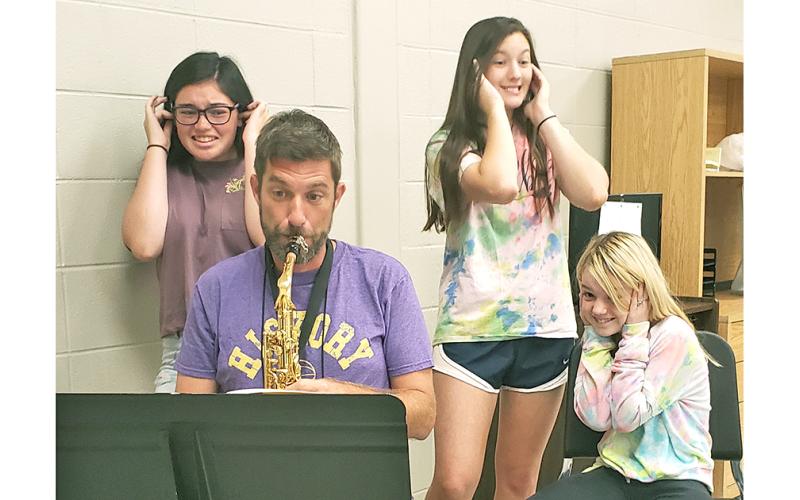 The sounds of the sax were a little less melodic when Nugget sportswriter Greg Finan, Jr. took part in the Fast Start Clinic Band Camp at LCMS last Saturday. Pictured (left to right): Instructors Jenna Crawford and Chasen Wood and camp participant Bethany Dix try to avoid the noise produced by Nugget sportswriter Greg Finan, Jr. playing the alto sax.