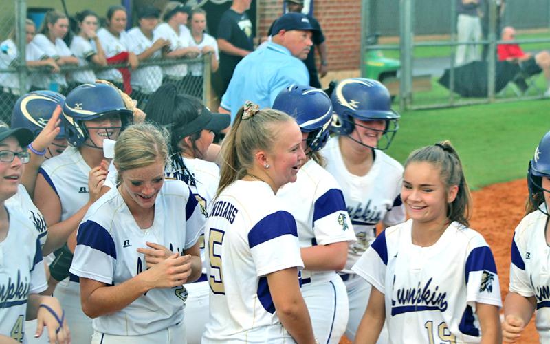 Evee Dornhecker is mobbed by her teammates after belting a game-tying solo shot to left field during the Lady Indians' game versus East Hall.