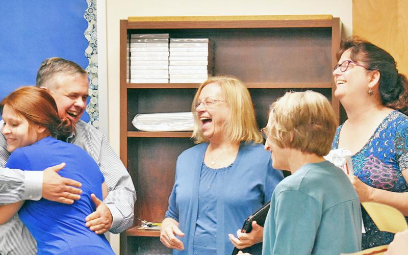 GED graduate Jennifer Welch hugs Geoffrey Kridel of Lumpkin Literacy alongside board members Barbara Adams, Shirley Christman and Karen Shepherd.
