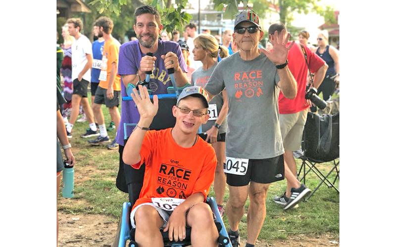 Nugget sportswriter Greg Finan, Jr. gets ready to head to the starting line with his Race for a Reason team of Logan (middle) and Hugo (right).