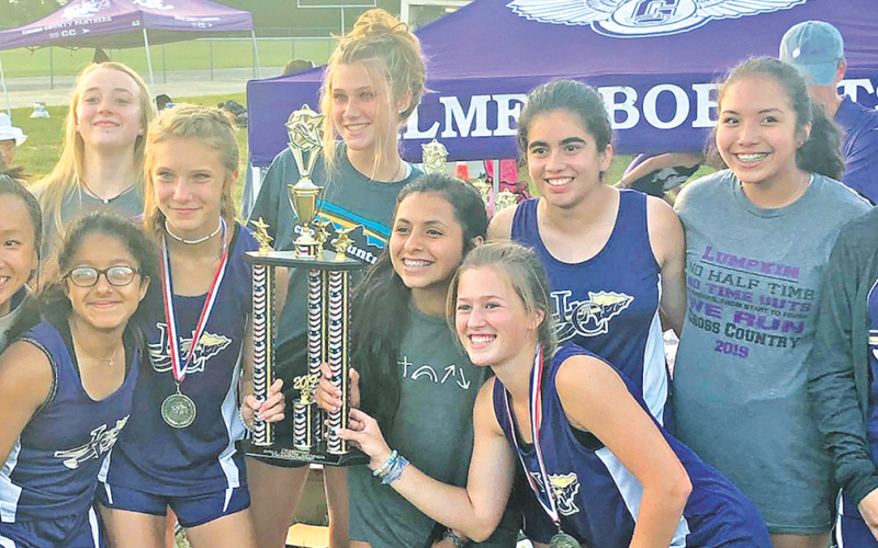 The Lady Indians cross country team shows off the hardware they earned after winning the Gilmer County Cross Country Invitational last week.