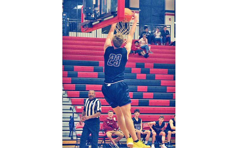 Indians player Peyton Polk adds an exclamation point on a fast break with a two-handed dunk against the Jackson County Panthers.