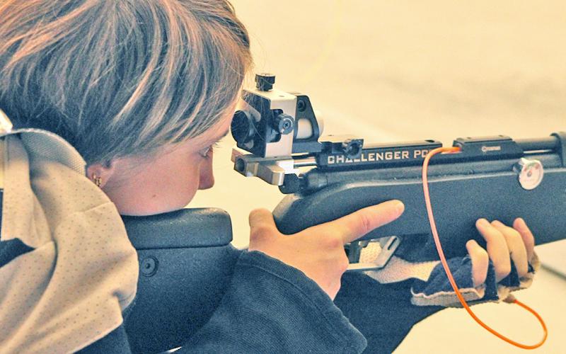 LCHS rifle team member Liv Lusky looks down her sights during the prone position portion of competition versus North Gwinnett last week.