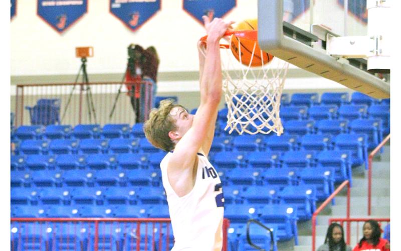 Lumpkin’s Peyton Polk throws down a dunk versus the Hurricanes in the Thanksgiving tournament.
