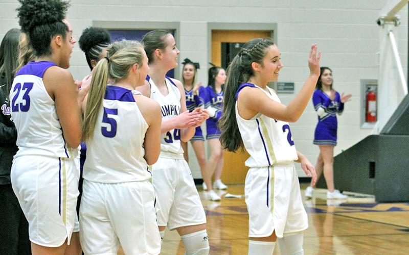 Lady Indians point guard Isabel Davenport receives congratulations from her teammates and recognition from the Lumpkin faithful after she knocked down the 1,000th point of her career against the GAC Lady Spartans at the Longhouse last week.