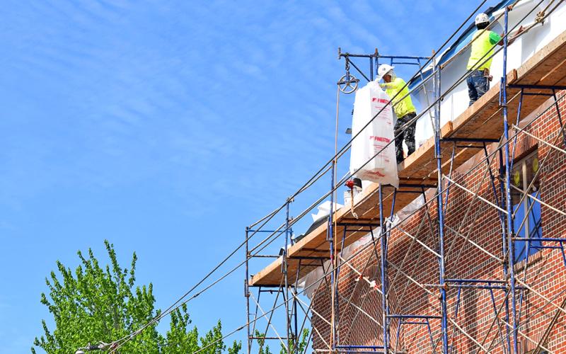 Though regular business has slowed to a halt on the square, construction has continued at a steady pace at the downtown hotel emerging on East Main Street. (photo by Matt Aiken)