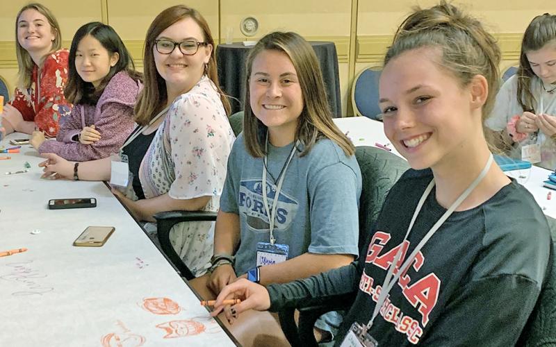 Members of the 2019-2020 LCHS yearbook staff (from right) managing editors Charlotte Cunningham and Olivia Gilleland, photo editor Lacy Gilreath and copy editors Autumn Cleymans and Brianne Anderson hone their yearbook design skills at the Herff Jones Yearbook Expo last July.