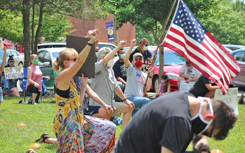 Community members gathered in Hancock Park to show support and unity during an anti-racism protest on Sunday afternoon.