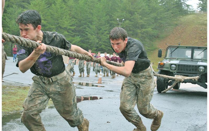Ian Daniel and Chance Burton use every ounce of strength their bodies can produce to help the other members of their team pull an army humvee.